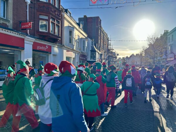 People dressed as elves parade through Weymouth