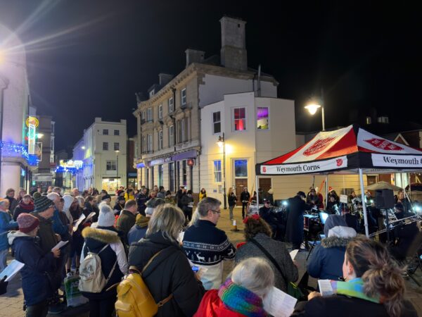 People singing Christmas Carols in Weymouth